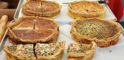 Quiches for sale in market.