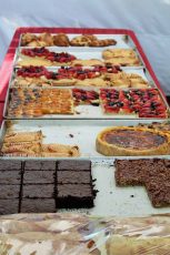 Pies and cakes showcased in outdoor vendor booth in Stuart FL.