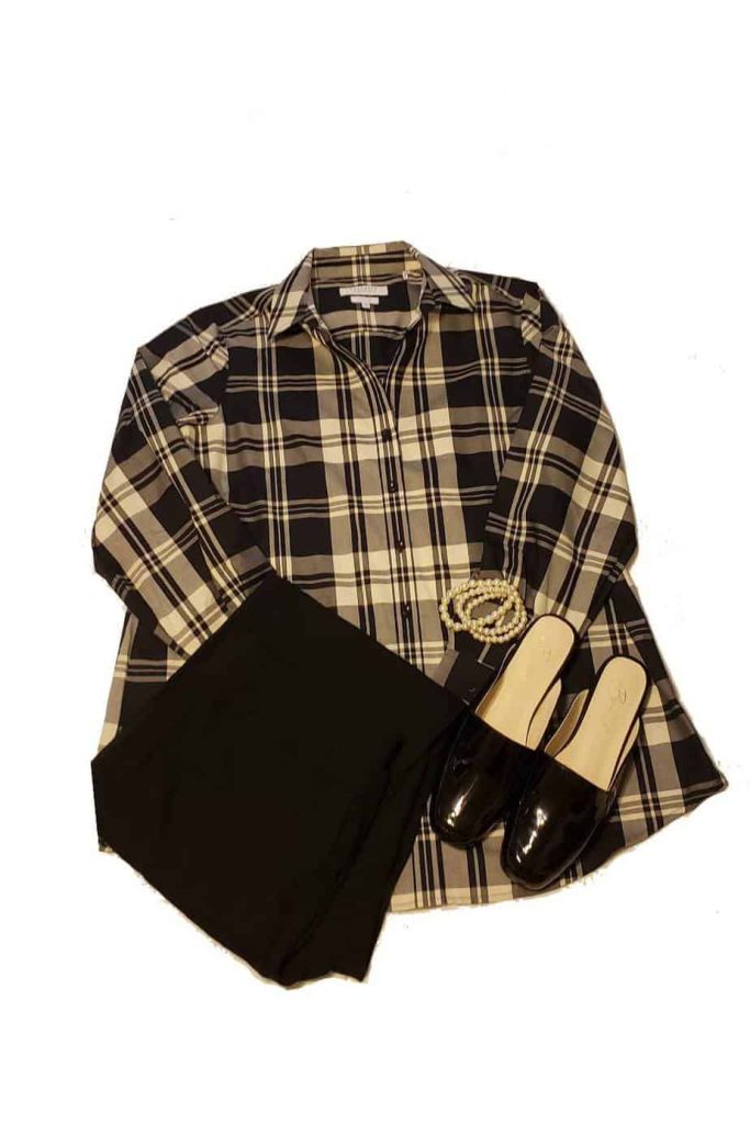 Classic Appleseed's plaid shirt, pearls, patent leather shoes and black pants.