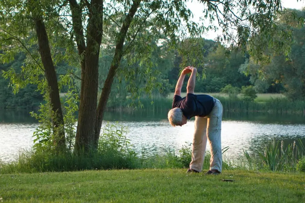 Man stretching on golf green.